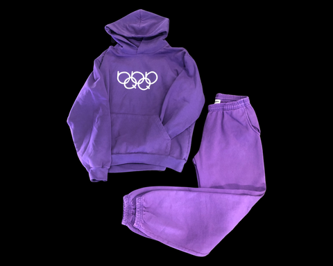 Streetwear Clothing Line: FREQUINCY - OlympiQ Rings Sweatsuit This HOUSE OF FREQUINCY Apparel piece is a jogger pant and long sleeve hoodie set in pigment dyed royal purple with puff printed graphics on a heavy fleece fabric with elastic ankle and adjustable drawstring.  Find this and more local and global apparel at The Fortt Urban Boutique in Sherman Oaks, CA. USA.