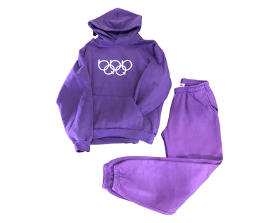 Streetwear Clothing Line: FREQUINCY - OlympiQ Rings Sweatsuit This HOUSE OF FREQUINCY Apparel piece is a jogger pant and long sleeve hoodie set in pigment dyed royal purple with puff printed graphics on a heavy fleece fabric with elastic ankle and adjustable drawstring.  Find this and more local and global apparel at The Fortt Urban Boutique in Sherman Oaks, CA. USA.